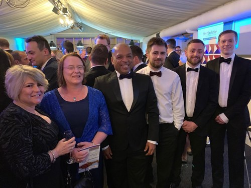 Group in black tie attire at awards ceremony