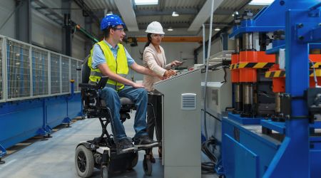 Man in wheel chair working on machinery 
