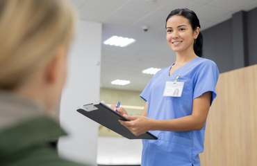 Healthcare Worker In Uniform Talking To Patient