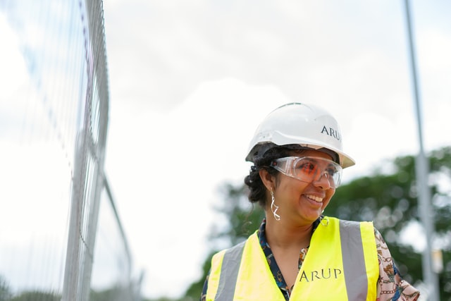 ARUP Female Project Manager On Site wearing high-vis, goggles and hard hat 