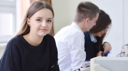 Young girl in electrical class smiling