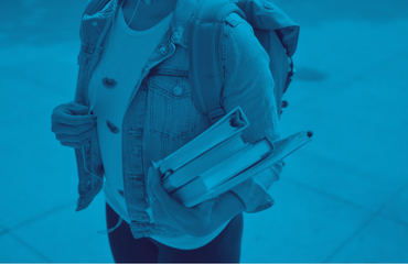 Someone walking with a rucksack on their back and a stack of books in their hands