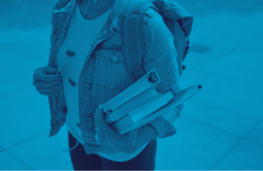 Student holding a pile of books