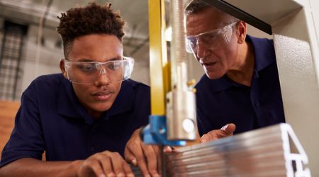 Young boy being mentored by an older man