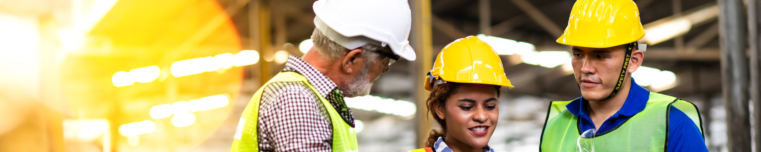 Two Men And Woman In Hard Hat And Construction Uniform