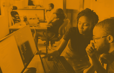 Man and woman working together on a computer 