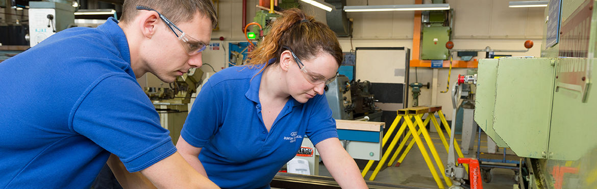 Male and female workers in a factory 